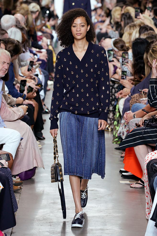 LOOK 6 - MIDNIGHT/GOLD ANCHOR EMBROIDERED CASHMERE PULLOVER, INDIGO DENIM PLEATED SKIRT, COURTNEY SHOULDER BAG