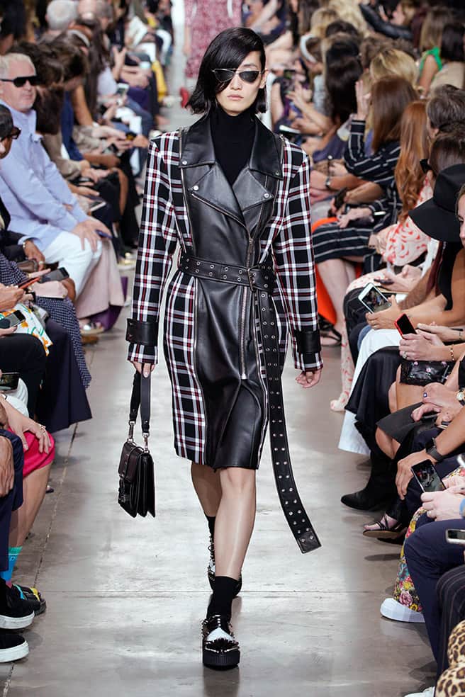 LOOK 50 - BLACK PLONGÉ MOTO TRENCH WITH BLACK/CRIMSON TARTAN COTTON PANELS, BLACK VISCOSE TURTLENECK BODYSUIT, SIMONE SHOULDER BAG